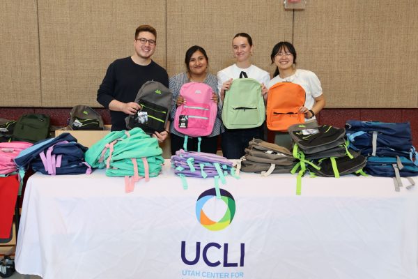 UCLI 2026 Ambassadors Eduardo Rios, Carolina Nunez, Ryan Calvert at the backpack table at Backman Elementary Back-to-School Night with UCLI Operations Manager Helen Wang on August 13, 2026.
