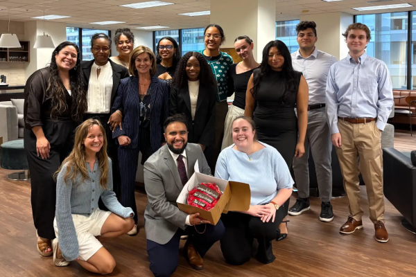 UCLI Fellows, Ambassadors, staff, and attorneys holding their celebratory LSAT cake.