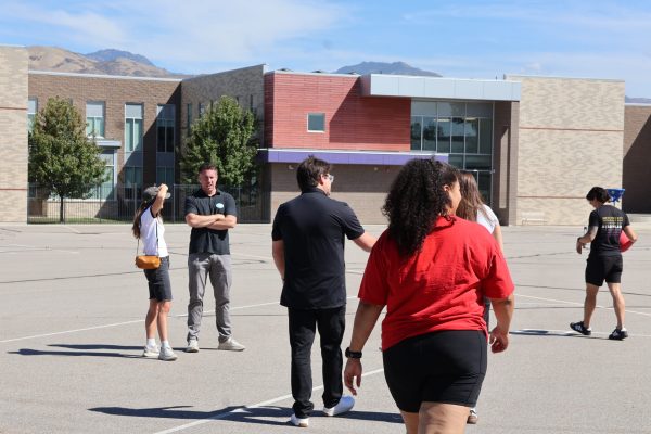Attorneys, interns, and staff gather around during the spirited round of kickball.